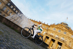Woman biking, bike tour, e-bike, Castle Square, New Castle, Stuttgart, Baden-Württemberg, Germany
