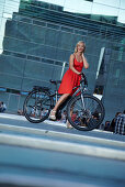 Woman cycling on an e-bike, bike tour, Schlossplatz, Art Museum, Stuttgart, Baden-Wurttemberg, Germany
