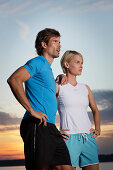 Couple wearing sports clothing at lake Starnberg, Bavaria, Germany