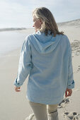 Woman walking on the beach, rear view