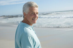 Portrait of man on the beach, smiling for the camera