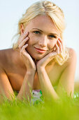 Young woman lying in grass