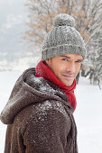 Young man in winter clothes looking at camera