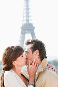 Couple kissing with the Eiffel Tower in the background, Paris, Ile-de-France, France
