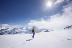 Mountaineer crossing a snowfield above Concordia, Grindelwald, Bernese Oberland, Switzerland