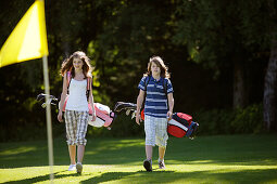 Children playing golf, Bergkramerhof, Bavaria, Germany