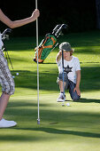 Children playing golf, Bergkramerhof, Bavaria, Germany