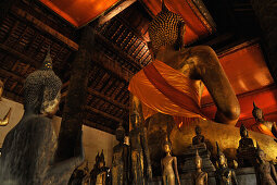 Big sitting Buddha from backside and many small Buddha staues at Wat Wisunarat, Wat Visoun, Luang Prabang, Laos