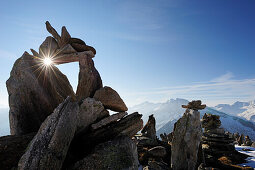 Cairn with sunstar, Zillertal mountain range, Zillertal, Tyrol, Austria