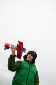 Boy playing with model airplane