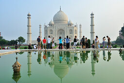 Taj Mahal and tourists reflecting in pond, Taj Mahal, UNESCO World Heritage Site, Agra, Uttar Pradesh, India