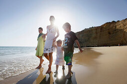 Mother and children walking on the beach, Conil de la Frontera, Costa de la Luz, Andalusia, Spain