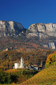 Herbstlich verfärbte Weinberge mit Kirche, Burg und Felsberge im Hintergrund, Eppan, Südtirol, Italien, Europa