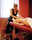 Woman enjoying traditional Hawaiian massage Lomi Lomi Nui in a spa resort, Travemuende, Luebeck, Schleswig-Holstein, Germany