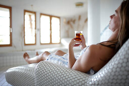 Woman enjoying a cup of tea in a spa hotel, Am Hochpillberg, Schwaz, Tyrol, Austria