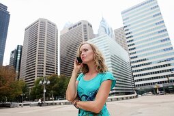 Business women talking by cellphone in Center City. Philadelphia. Pennsylvania. USA