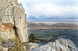 Rock climbing a route called Sancho Rama which is rated 5, 10 and located on the Upper Comp Wall at Castle Rocks State Park near the town of Almo in southern Idaho