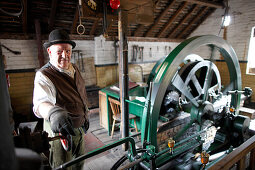 Volunteer explains steampowered flywheel to visitors, The Iron Gorge Museums, Blists Hill Victorian Town, Ironbridge Gorge, Telford, Shropshire, England, Great Britain, Europe