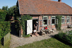 Family in a garden, Klein Thurow, Roggendorf, Mecklenburg-Western Pomerania, Germany
