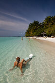 Woman snorkeling off the beach of Kurumba Island, North Male Atoll, Indian Ocean, Maldives