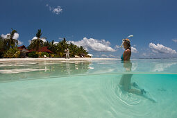 Woman with snorkel in the shallow water, North Male Atoll, Indian Ocean, Maldives