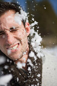 Man getting hit in face by snowball