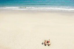 Couple sunbathing on white sandy beach. Couple sunbathing on white sandy beach