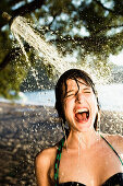 Woman standing in shower at beach. Woman standing in shower at beach
