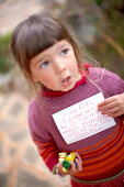 Girl with sweets and a letter, Santanyi, Majorca, Balearic Islands, Spain