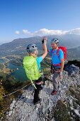 Young woman and young man reaching summit at fixed rope route Rino Pisetta, Lago die Toblino, Sarche, Calavino, Trentino, Trentino-Alto Adige, Suedtirol, Italy