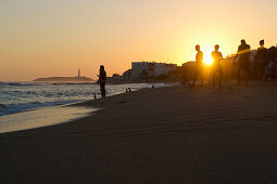 People on the beach at sunset, Cabo de Trafalgar in the background, Los Canos de Meca, Andalusia, Spain, Europe