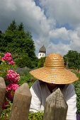 Gardener working in the Abbey garden, Fraueninsel, Chiemsee, Chiemgau, Bavaria, Germany