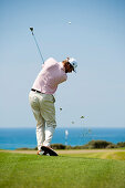 Golf player playing iron to green at golf course Navarino Dunes, Costa Navarino, Peloponnese, Greece, Europe