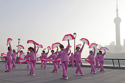 Morning exercises, women doing fan dance at the Bund in the morning, Shanghai, China