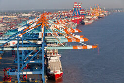 Aerial view of container port Bremerhaven, freighters being loaded by cranes, Weser Rivermouth, Bremerhaven, Bremen, Northern Germany