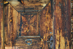 Old wooden door at farmhouse, Strassberg, Walserweg, Arosa, Grisons, Switzerland
