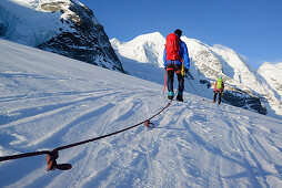 Roped party ascending on Cambrena glacier, ascent to Piz Palue, Grisons, Switzerland