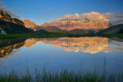 Sella range reflecting in a mountain lake, Val Gardena, Dolomites, UNESCO world heritage site Dolomites, South Tyrol, Italy