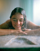 Woman enjouying a rain shower in a spa, Langenlois, Lower Austria, Austria