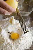 Grating lemon into pastry, together with flour and egg, baking, Homemade