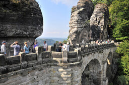 People on the stone bridge at the Bastei, Saxonien Switzerland, Saxony, Germany, Europe