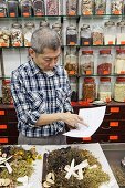 China,Hong Kong,Sheung Wan,Chinese Medicine Shop,Pharmacist Checking Prescription List