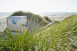 White Beachchair, sandbank near Nebel, Amrum, North Frisian Islands, Schleswig-Holstein, Germany