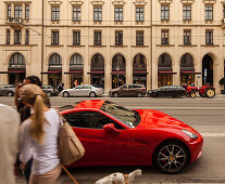 Red Ferrari and tractor in Maximilian street, shopping girl with dog, Munich, Upper Bavaria, Bavaria, Germany