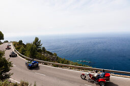 Trikes on winding coast road at Mediterranean Sea, Estellencs, Mallorca, Spain