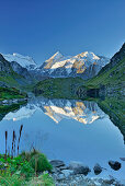 Grand Combin, Combin de Corbassiere and Petit Combin reflecting in a mountain lake, Pennine Alps, Valais, Switzerland