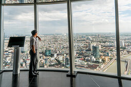 Young man looking towards the city of Saigon, south Vietnam, Vietnam, Asia