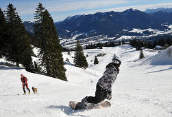 Hikingskier and boarder on a skirun, skiarea Brauneck near Lenggries, Bavarian Alps, Germany