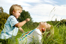 Mother and son (3 years) playing on grass