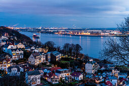 Twilight over Blankenese Treppenviertel with the river Elbe and airbus factory in the background, Hamburg, Germany